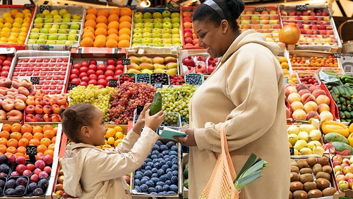 woman-and-child-selecting-fruit-from-a-grocery-store